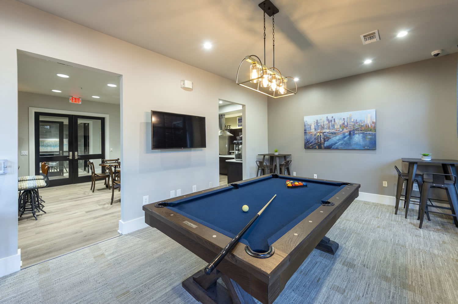 Apartments in Uptown Houston, Galleria Area An upscale living room in a Galleria Area apartment featuring a pool table and a sleek flat screen TV.